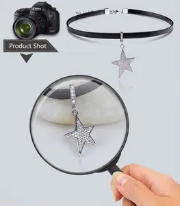 Detailed close-up of a black choker necklace featuring a star pendant with white zircon