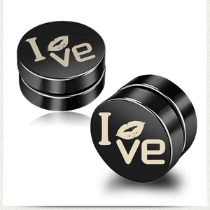 Macro view of black magnetic clip-on earrings with I Love heart-lips pattern
