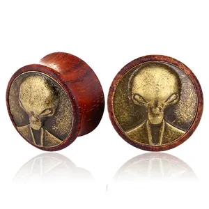 Vintage wood ear plugs with alien head metal inlay shown from two display angles