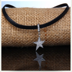 Classic pentagram star choker with sparkling zircons on a textured black leather cord