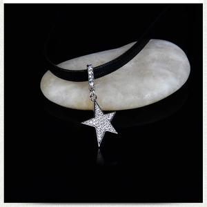 Minimalist star pendant choker necklace with sparkling crystals on black cord