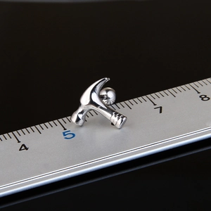 Polished stainless steel hammer-shaped stud earring shown on a ruler for size measurement