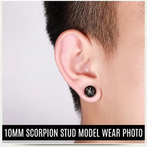 Close-up of 10mm black magnetic earring with white scorpion print on model's ear