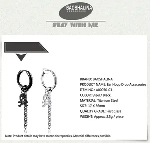 Detail view of titanium steel skull pendant long chain earrings in black and silver finishes
