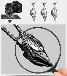 Macro shot of realistic raven skull pendant with vintage steel texture and carvings