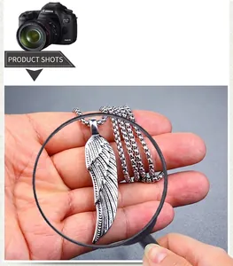 Macro view of detailed feather carving on vintage silver stainless steel pendant