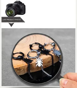 Detailed view of spider pendant earring with long chain in silver and black finishes