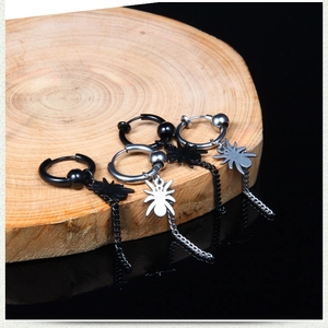 Detailed view of punk spider earrings with tassel chains in black and silver finishes