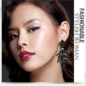 Close-up of luxury black rhinestone teardrop earrings on a model in vintage style