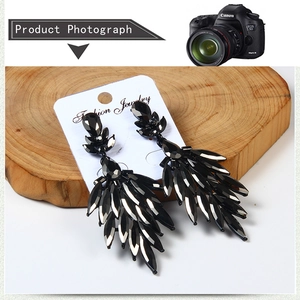 Macro view of luxurious black teardrop fringe earrings with multi-faceted crystals