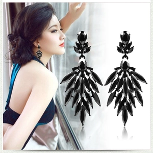 Luxurious black multi-faceted teardrop earrings in leaf design shown on model