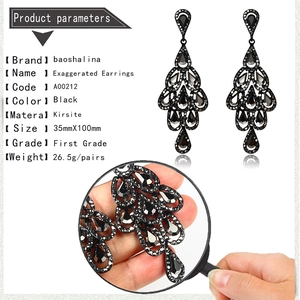 Macro detail of luxury black teardrop earrings showing intricate crystal stone settings