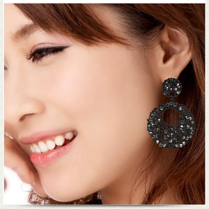 Close-up of luxury black rhinestone drop earrings featuring double geometric circles