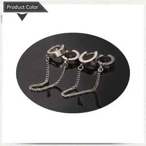 Detail view of silver stainless steel clip-on earrings with long punk style chains