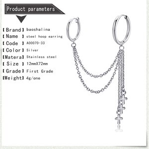 Detail view of silver stainless steel hoop earrings with chain and three cross pendants