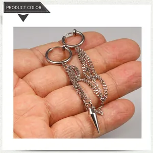 Detail view of silver stainless steel hoop earrings with layered tassel chains and spikes