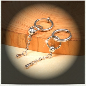 Silver stainless steel hoop earring with long chain and teardrop pendant on wood