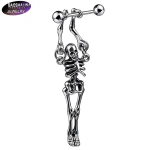 Detailed view of a silver stainless steel skull charm on a gothic industrial barbell earring