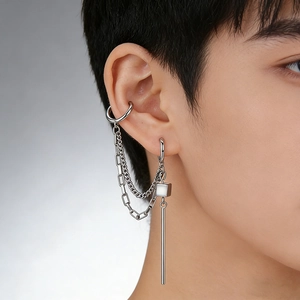 Detail of silver chain earring with cuff and square pendant on ear for punk style