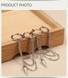 Close-up of punk style stainless steel tassel earrings with double chain and cone pendant