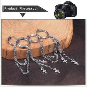 Detail view of punk stainless steel hoop earrings with layered chains and cross pendants