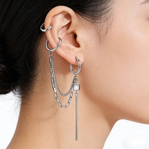 Close-up of silver steel chain earrings with tassel drop on model ear profile
