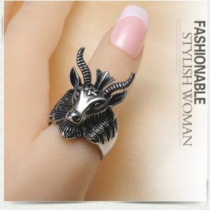 Macro shot of vintage steel goat head ring showing intricate Baphomet textures and details