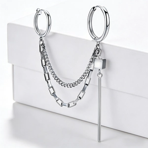 Detail of stainless steel hoop earrings with punk chains, square and cylinder pendants