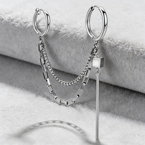 Detail of silver steel chain earrings with tassel pendant and dual hoop punk design