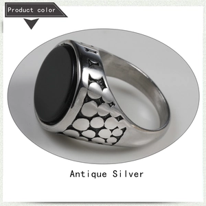 Detailed macro view of retro men's steel ring with antique silver finish and black gemstone