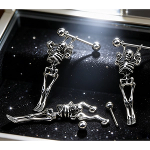 Gothic punk skull earrings in polished stainless steel on a black jewelry box background