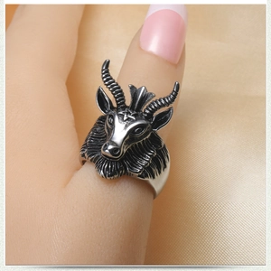 Macro shot of ram head ring with intricate goat horns and pentagram detail in retro style