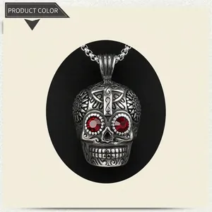 Gothic skull pendant necklace with red gemstone eyes and cross carving detail
