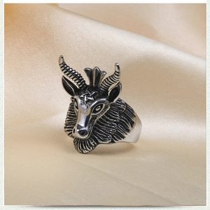 Vintage gothic sheep head ring in stainless steel with pentagram detail on satin fabric