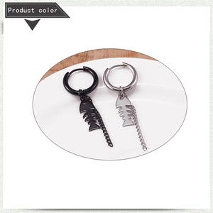 Detailed view of silver and black stainless steel tassel earrings with fishbone pendants