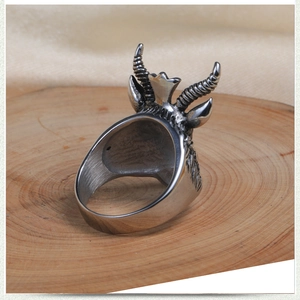 Detailed close-up of a vintage stainless steel ram head ring with intricate textures