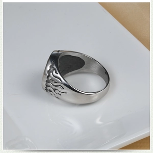 Macro shot of vintage stainless steel men's ring with embossed flame textures
