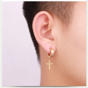 Polished gold stainless steel hoop earring with a minimalist cross pendant on model