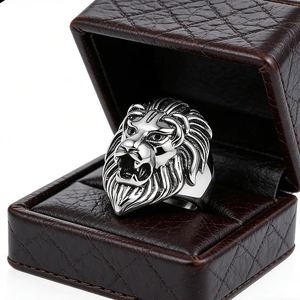 Detailed view of silver lion head ring on brown leather box with sharp metal texture
