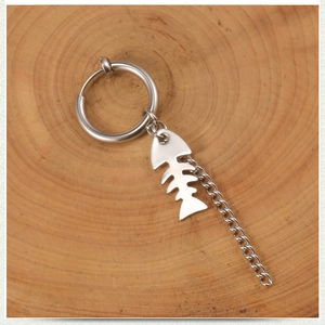 Silver punk tassel earrings with fishbone pendant and long chain on wooden base