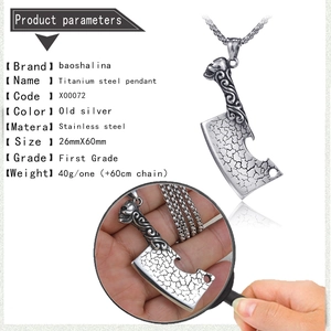 Detail of vintage stainless steel butcher knife pendant with engraved skull handle