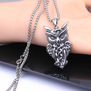 Macro shot of owl head pendant with Celtic knot details and matte silver finish