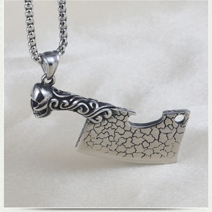Detail of gothic skull handle meat cleaver pendant with vintage cracked texture