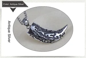 Detailed view of vintage silver wolf tooth pendant with engraved patterns on bead chain
