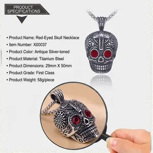 Macro view of antique silver skull pendant with red rhinestone eyes and cross engraving