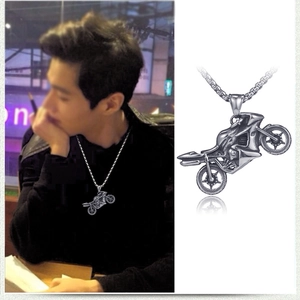 Macro detail of silver stainless steel motorcycle pendant with box chain for men