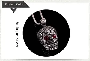 Detail of gothic steel skull pendant with red rhinestone eyes and engraved cross