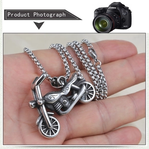 Detail shot of vintage stainless steel motorcycle pendant with retro box chain for men