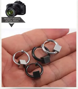 Gros plan de boucles d'oreilles cubes en acier inoxydable, noir et argent