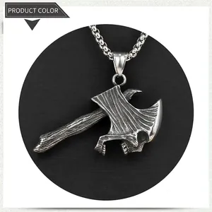 Close-up of retro stainless steel gothic skull battle axe pendant with box chain